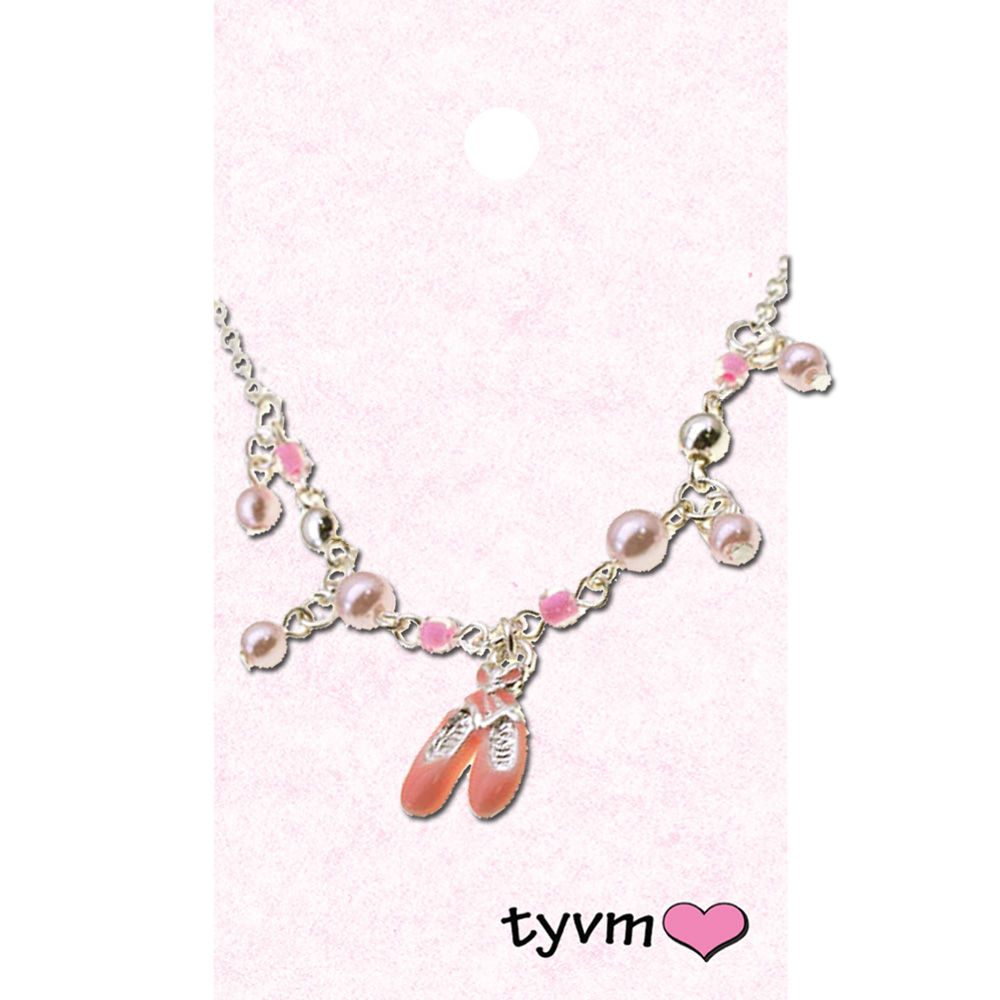 A necklace with pink beads and a pair of ballet shoes.